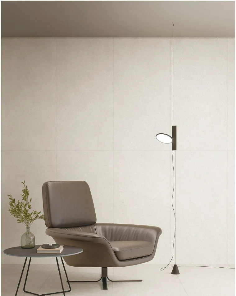 Neutral interior showing large-format pale tiles aligned across a wall and floor