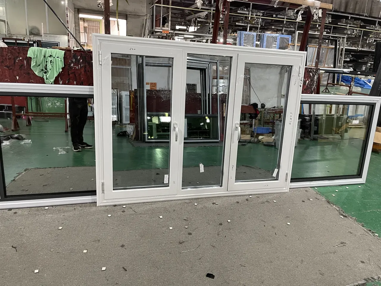 White glazed window units with operable sashes and fixed panels in a workshop