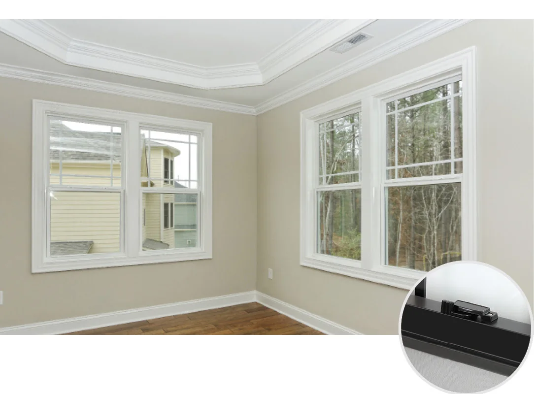 White-framed vertically sliding windows with divided panes in a bright room