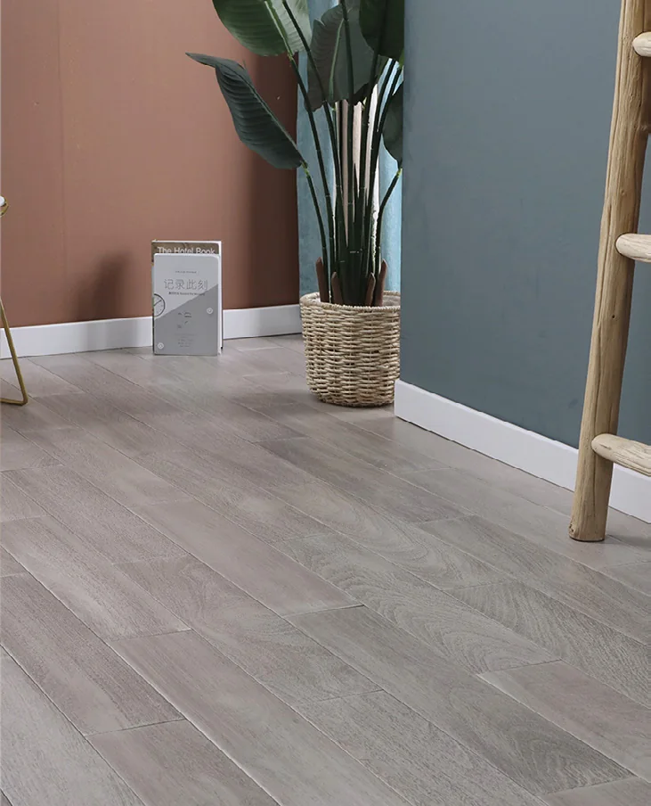 Grey-toned wood flooring laid in straight planks beneath a chair