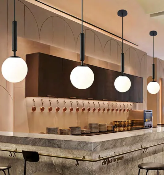 Small globe pendants suspended above a kitchen counter