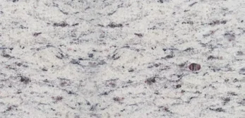 Pale granite sample with irregular streaks and darker grains