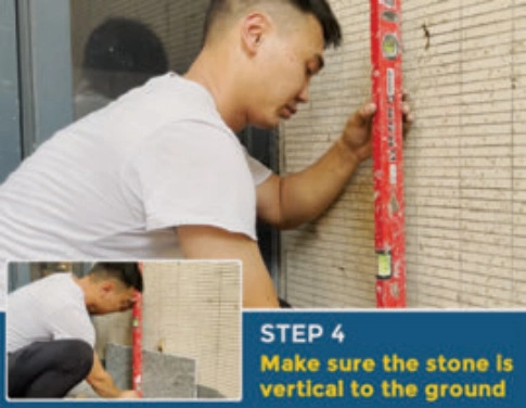 Worker checking stone wall cladding with a level; Step 4: Make sure the stone is vertical to the ground