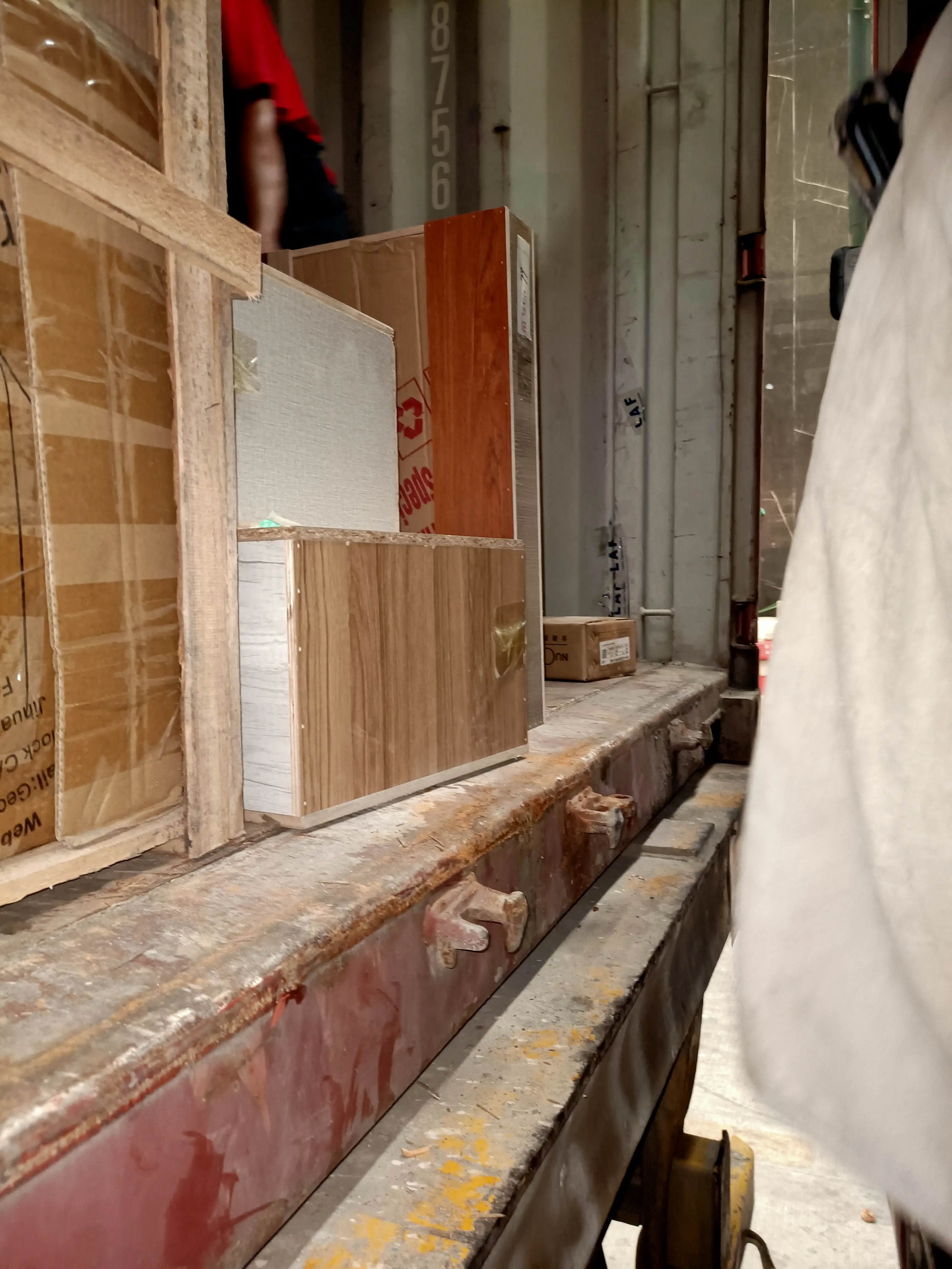 Wooden crates and wrapped upright panels packed inside a shipping container