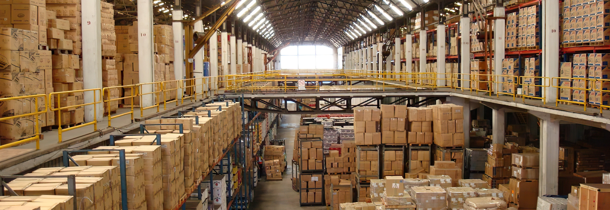 Warehouse with cartons and crated goods stored across multiple levels